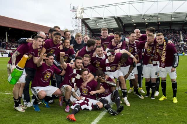 The Hearts squad celebrate on the pitch. Picture: SNS