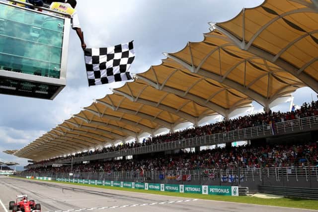 Germany's Sebastian Vettel takes the chequered flag at the Malaysian Grand Prix. Picture: Getty
