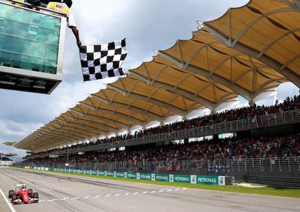 Germany's Sebastian Vettel takes the chequered flag at the Malaysian Grand Prix. Picture: Getty