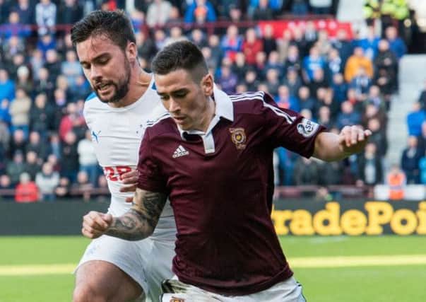McGregor challenges Jamie Walker during the match that would put Hearts nine points clear of Rangers. Picture: Ian Georgeson