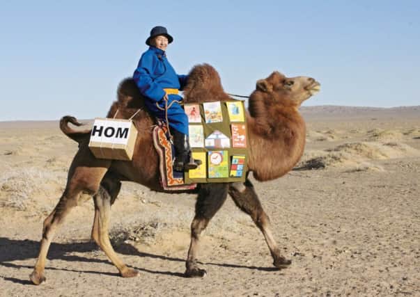 A camel delivers books to remote communities in the Gobi desert. Pictrue: Contributed