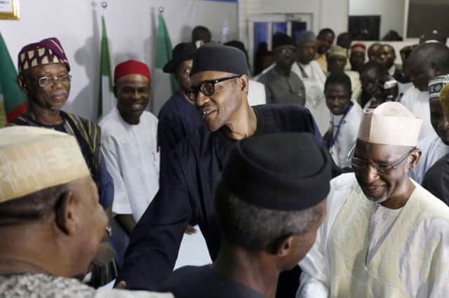 Muhammadu Buhari greets party officials after Goodluck Jonathan conceded defeat. Picture: AP