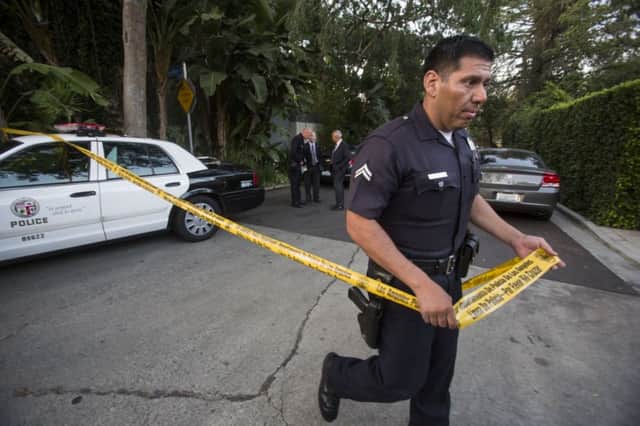 Police at the house of Andrew Getty, who was found dead. Picture: AP