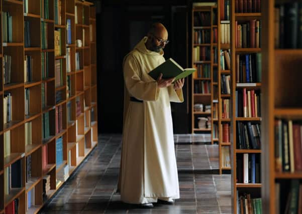 A monk reads in the library of the abbey. Picture: Ian Rutherford