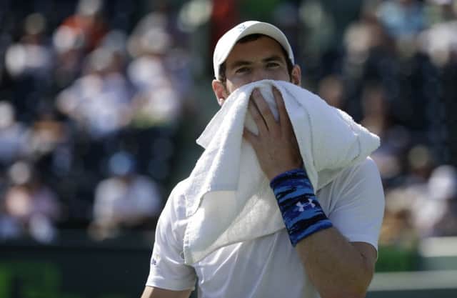 Andy Murray wipes his face with a towel during his hard-fought win over Dominic Thiem. Picture: AP