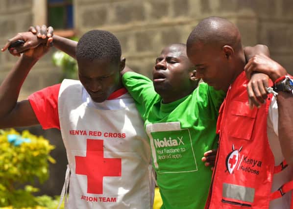 Relatives of the victims of the Garissa University College were comforted by Kenyan Red Cross workers. Picture: Getty