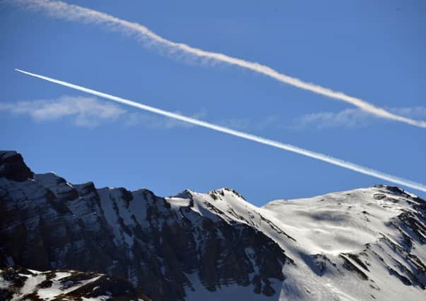 A trail in the blue sky over the mountains left by airplanes near the site of the Germanwings plane crash. Picture: Getty