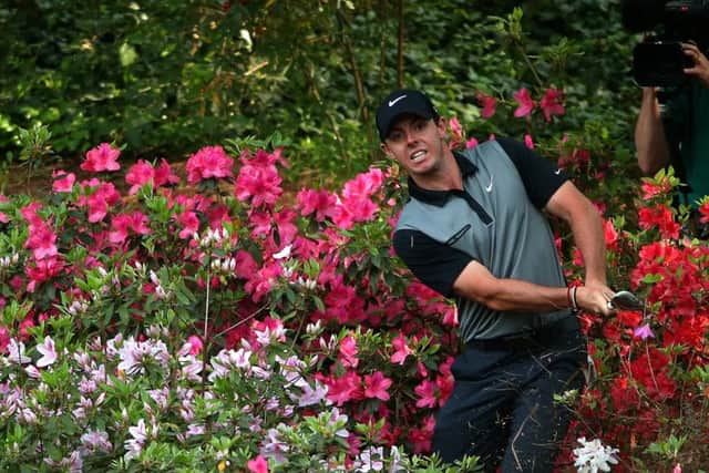 Rory McIlroy hits a shot out of the azalea bushes behind the 13th green during the second round of the 2014 Masters at Augusta. Picture: Andrew Redington/Getty