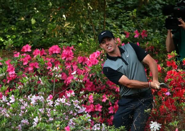Rory McIlroy hits a shot out of the azalea bushes behind the 13th green during the second round of the 2014 Masters at Augusta. Picture: Andrew Redington/Getty