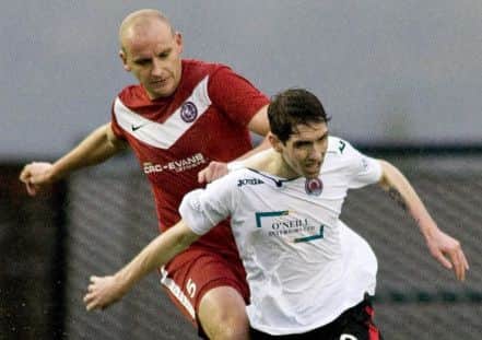 Brora's Grant Munro holds off Clydes Stefan McCluskey in a 2013 Scottish Cup tie. Picture: SNS