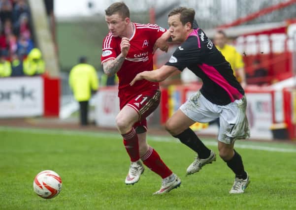 Jonny Hayes (left) battles with James Craigen. Picture: SNS