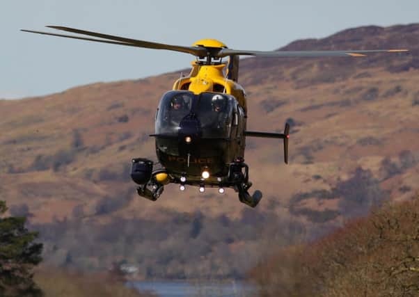 A rescue helicopter at the scene yesterday. A coastguard officer said that cloud cover was down to 100 metres the previous day when the crash happened. Picture: SWNS