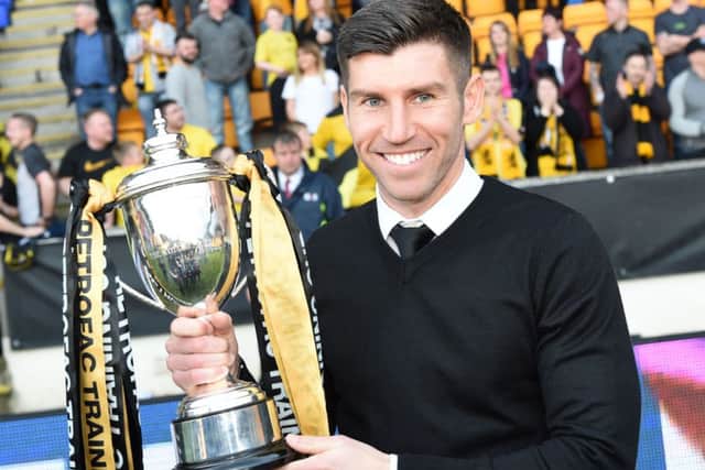 Livingston manager Mark Burchill celebrates with the Petrofac Training Cup. Picture: SNS