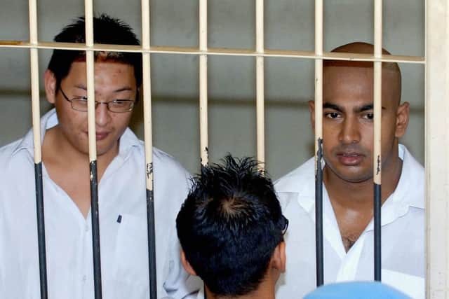 Australian drug traffickers Andrew Chan, left, and Myuran Sukumaran look on from a holding cell. Picture: AFP/Getty