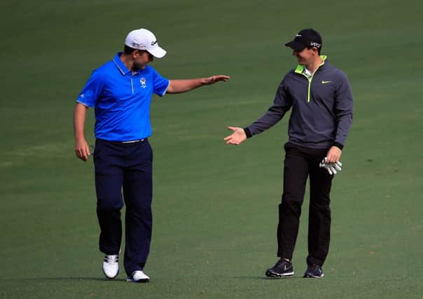 Blairgowrie's Bradley Neil, left, is congratulated by his practice partner Rory McIlroy. Picture: Getty