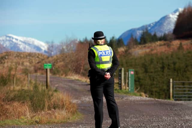 A police officer at Inverawe, Argyll, near the scene where the aircraft crashed on Glen Kinglass. Picture: Hemedia