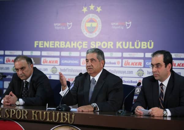 Fenerbahce vice-president Deniz Tolga Aytore, left, Fenerbahce vice-president Mahmut Uslu and Fenerbahce vice-president Sekip Mosturoglu give a press conference. Picture: PA
