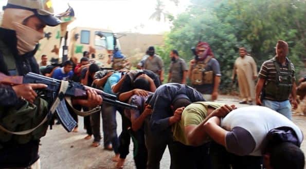 An image released by Islamic State last June shows its fighters leading away captured Shiites in Tikrit. Picture: AP