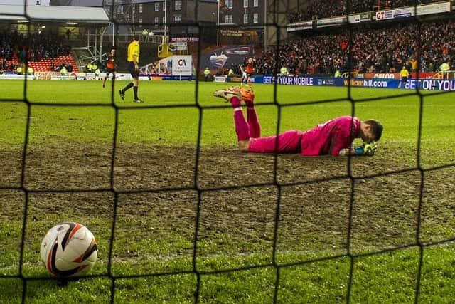 Dundee goalkeeper Arvid Schenk is a picture of despair after Dundee United score their sixth goal. Picture: SNS