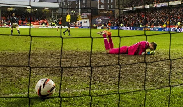 Dundee goalkeeper Arvid Schenk is a picture of despair after Dundee United score their sixth goal. Picture: SNS