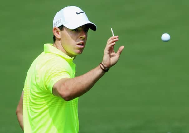Rory McIlroy gets his eye in as he catches a ball during practice at Augusta. Picture: Getty