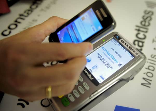 An increasing number of shoppers are embracing mobile transaction technology. Picture: AFP