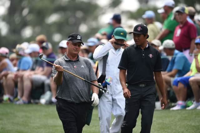 Sandy Lyle shows Yang Gunn of South Korea one of his hickory clubs as they play. Picture: AFP/Getty