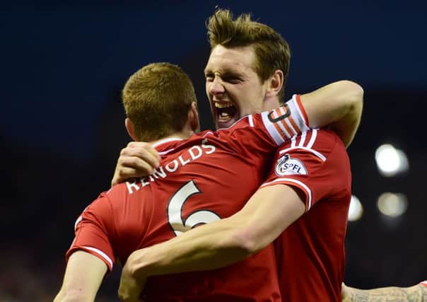 Aberdeen's Ash Taylor (right) celebrates with team-mate Mark Reynolds having opened the scoring for his side. Picture: SNS