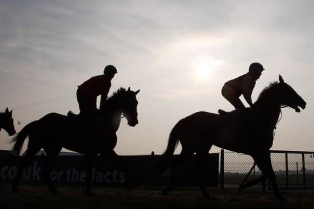 Horses and riders out in the early morning ahead of the Grand National Festival. Picture: PA