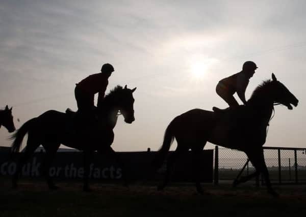 Horses and riders out in the early morning ahead of the Grand National Festival. Picture: PA