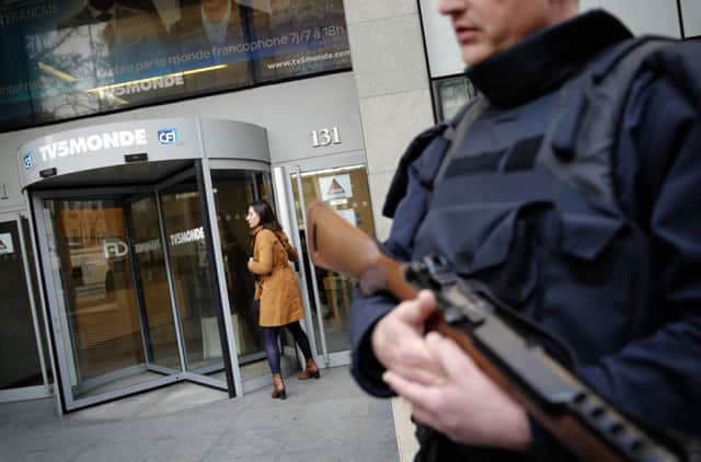 A policeman outside TV5 Mondes Paris headquarters. Picture: AP