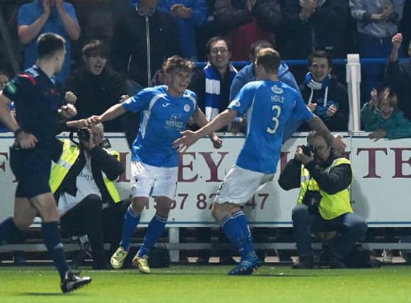 Gavin Reilly (left) celebrates putting his side 3-0 up. Picture: SNS