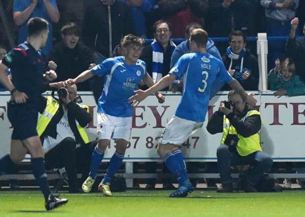 Gavin Reilly (left) celebrates putting his side 3-0 up. Picture: SNS