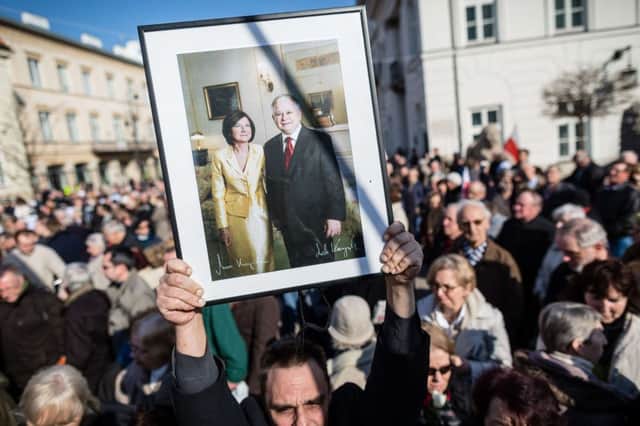 A man holds a portrait of Lech and Maria Kaczynski on the fifth anniversary of the crash. Picture: AFP