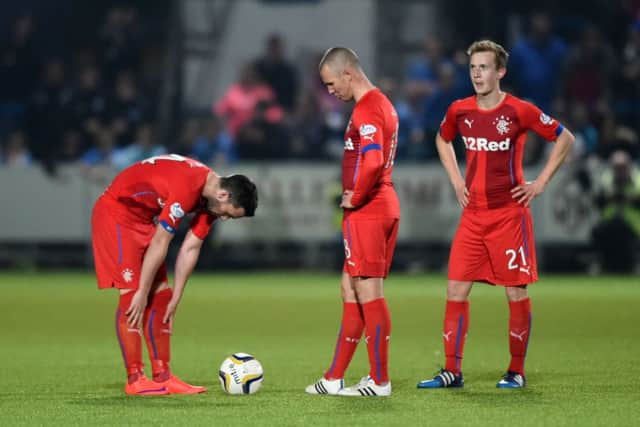 Kenny Miller looks downcast as Rangers prepare to restart the match. Picture: SNS