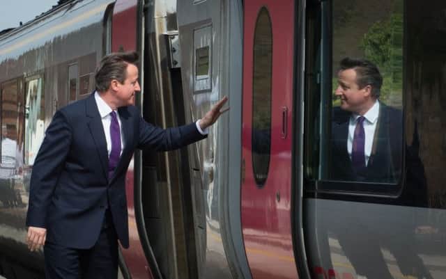 David Cameron waves off his train after arriving in Devon. Picture: PA