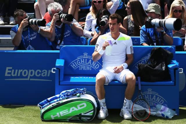 Andy Murray takes a swig of mineral water during a break at Queens Club. Picture: Steve Bardens/Getty