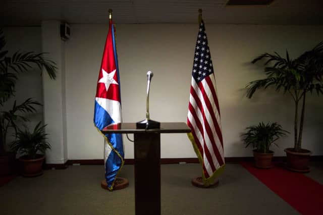 The Cuban and US flags stand side by side before the start of a press conference in Havana. Picture: AP