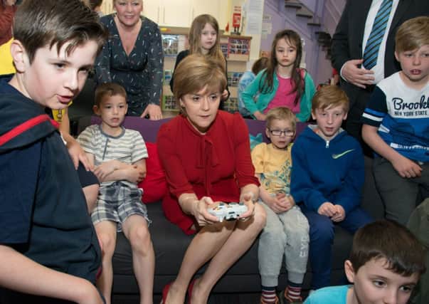 First Minister Nicola Sturgeon and Midlothian candidate Owen Thompson visit an after-school club. Picture: Andrew O'Brien