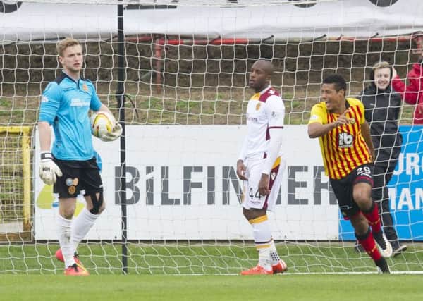 Partick Thistle's Lyle Taylor wheels away to celebrate after scoring his goal. Picture: SNS