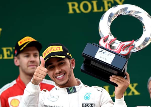 It was thumbs-up for Lewis Hamilton on the podium in Shanghai yesterday, with victory moving the Englishman 13 points clear in the drivers standings. Picture: Getty