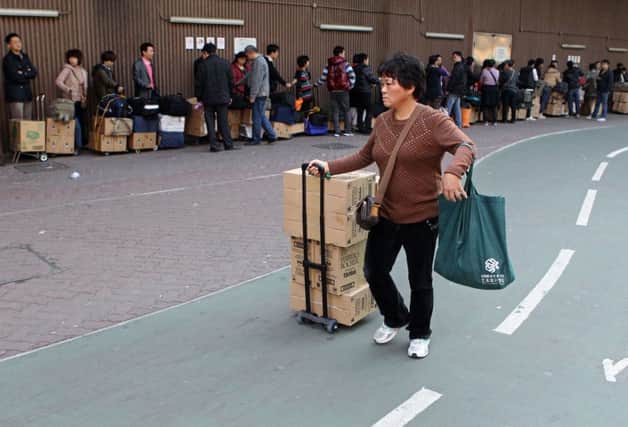 A shopper waits for a train at Sheung Shui Station in Hong Kong. Picture: Getty