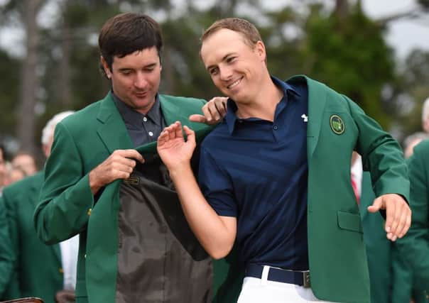 Bubba Watson, the 2014 champion, helps Jordan Spieth into the Green Jacket. Picture: Getty