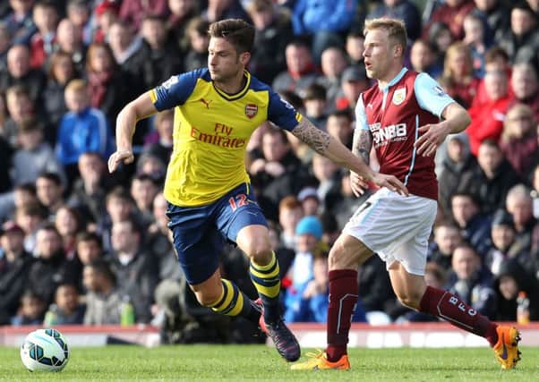 Olivier Giroud holds off Scott Arfield as Arsenal take on Burnley in the English Premier League. Picture: Getty