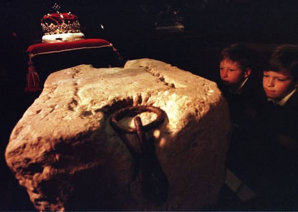 Two young children look at the Stone of Destiny at Edinburgh Castle. Picture: TSPL