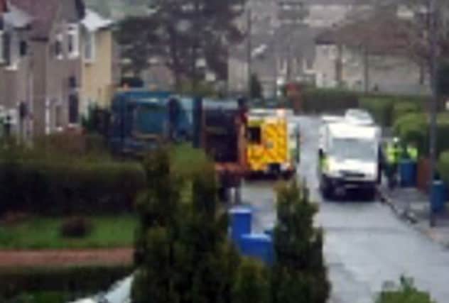 The bin lorry can be seen in the front garden with emergency services in attendance. Picture: Caroline Dunnett