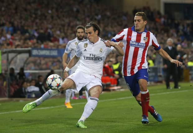 Real Madrids Gareth Bale fights for the ball with Atleticos Koke. Picture: Andres Kudacki/AP