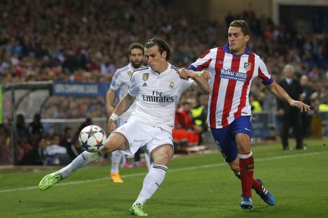 Real Madrids Gareth Bale fights for the ball with Atleticos Koke. Picture: Andres Kudacki/AP