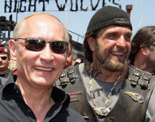 Vladimir Putin, left, with Night Wolves bikers club leader Alexander Zaldostanov. Picture: Getty