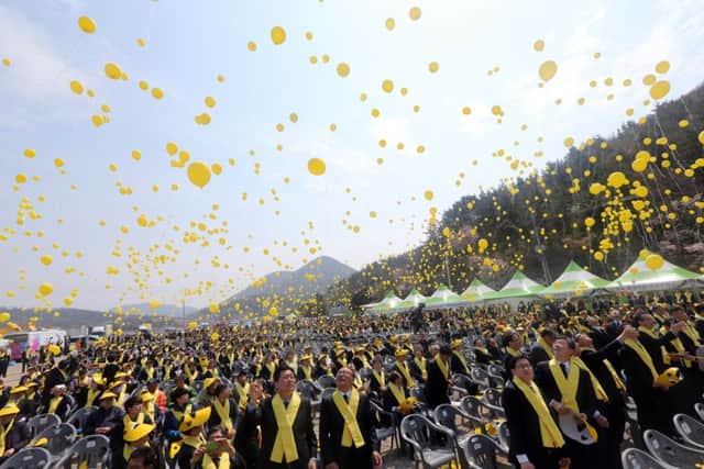 Hundreds of yellow balloons are released during a ceremony in Jindo, South Korea. Picture: AP